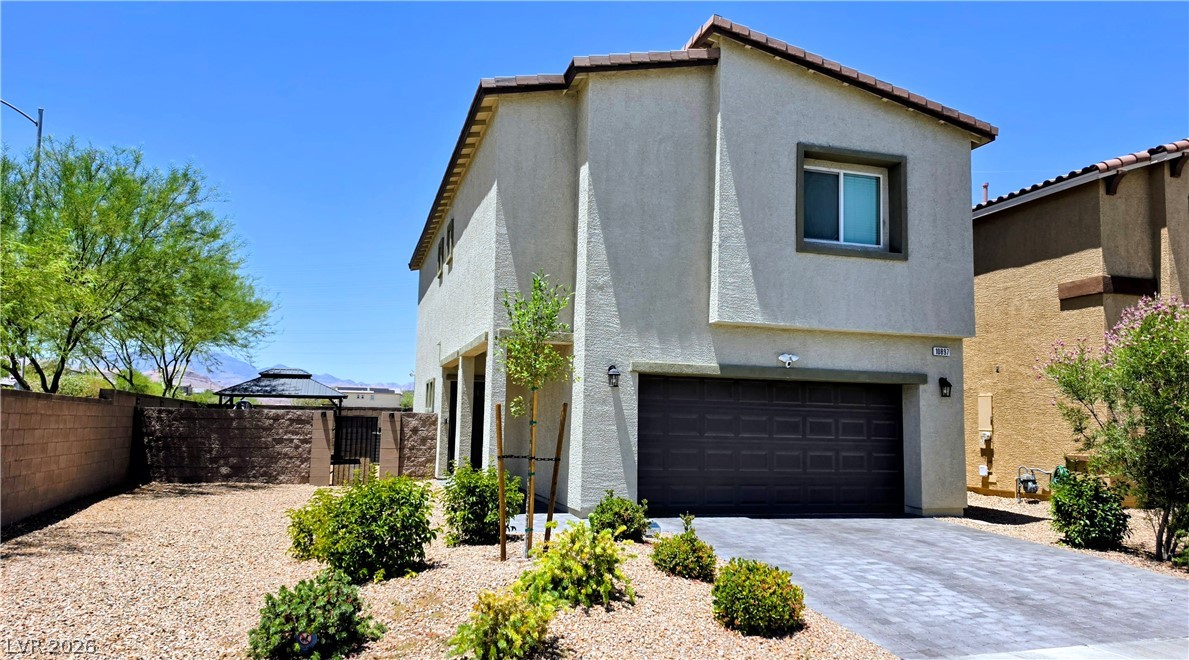 10897 Lexus Court Las Vegas, NV 89141 - Photo 1 of 1 Modern desert landscaping with a two-story residence, featuring an integrated garage and a fully fenced yard.