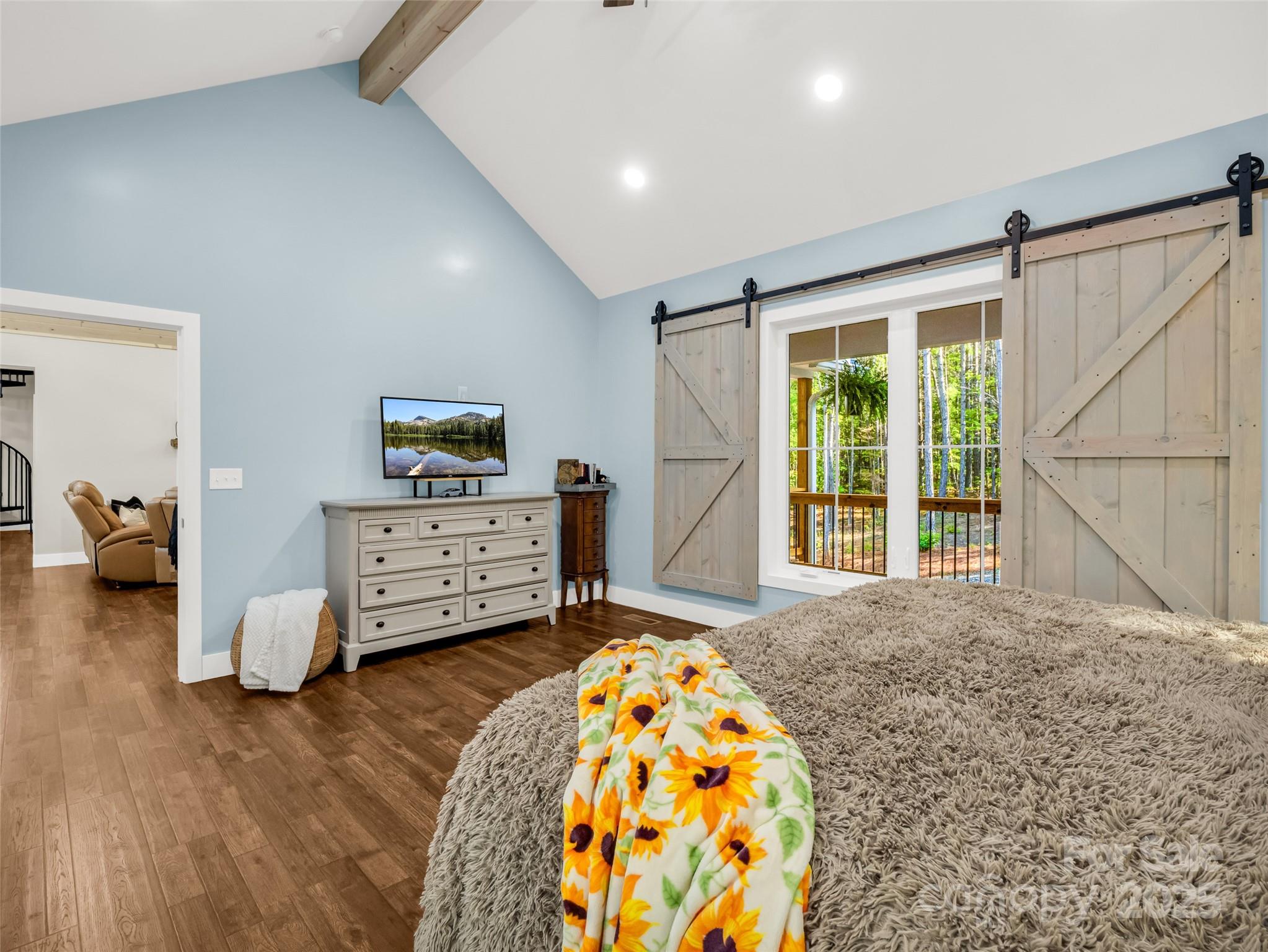 110 Geebees Way Mill Spring, NC 28756 - Photo 24 of 48 a spacious bedroom with a bed and wooden floor