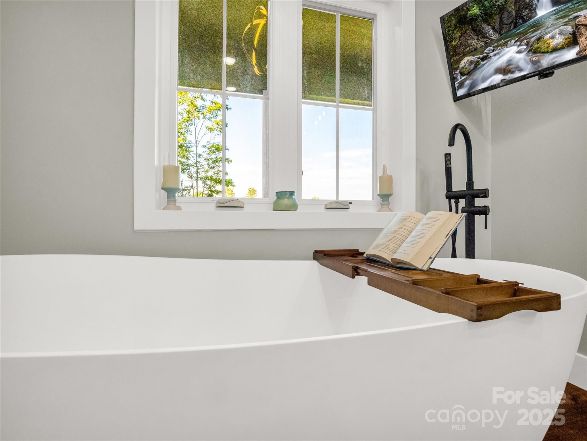 110 Geebees Way Mill Spring, NC 28756 - Photo 27 of 48 a bath tub sitting next to a window