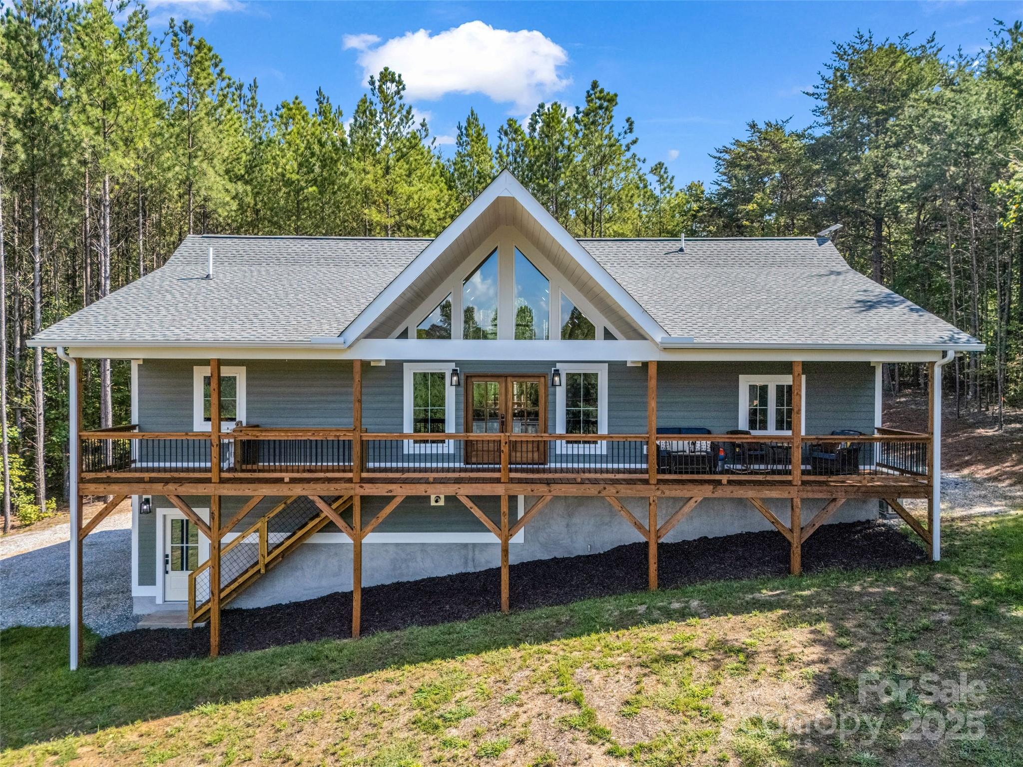 110 Geebees Way Mill Spring, NC 28756 - Photo 39 of 48 a front view of house with a yard and balcony