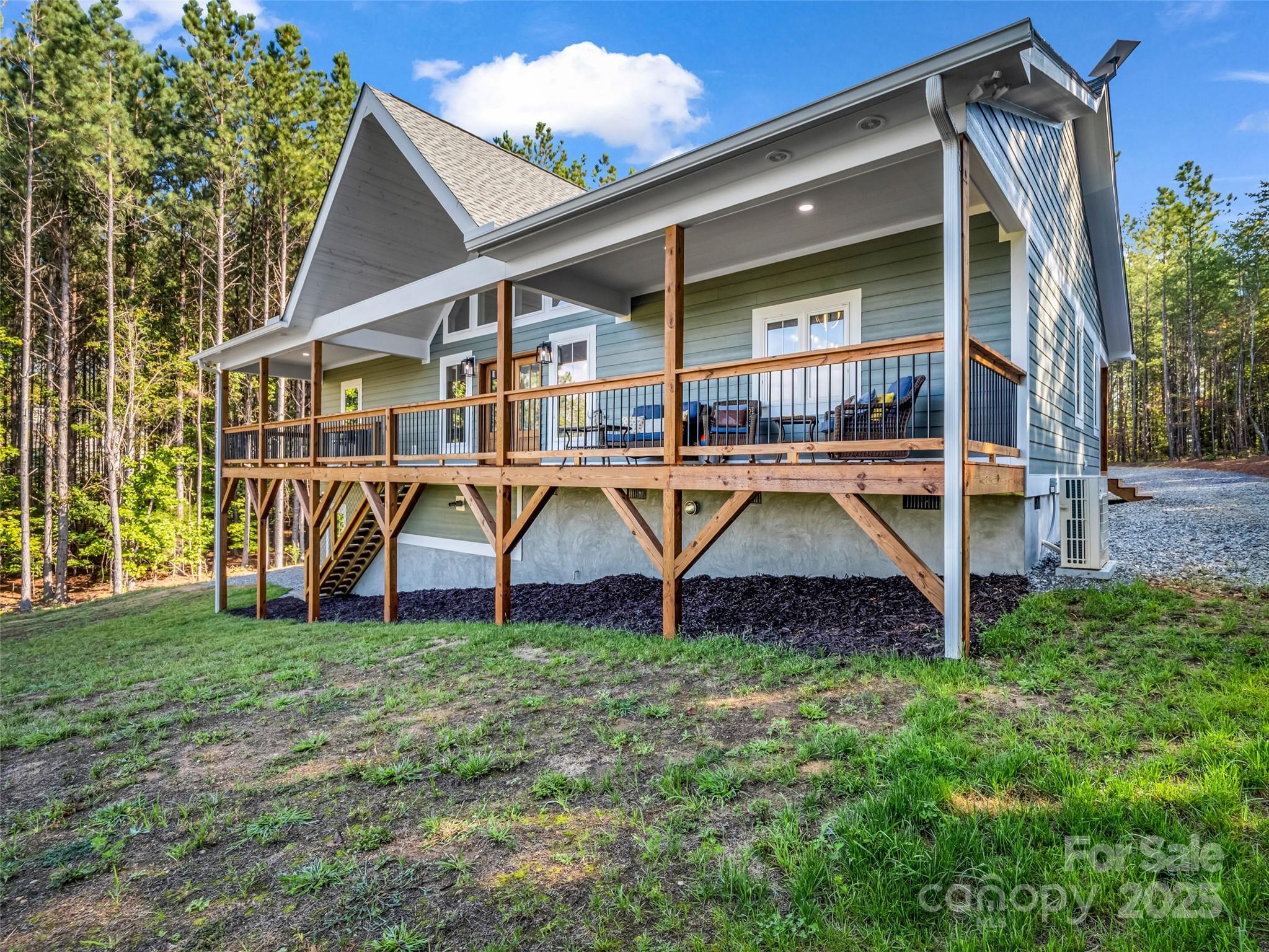 110 Geebees Way Mill Spring, NC 28756 - Photo 6 of 48 a view of a house with wooden deck and a yard