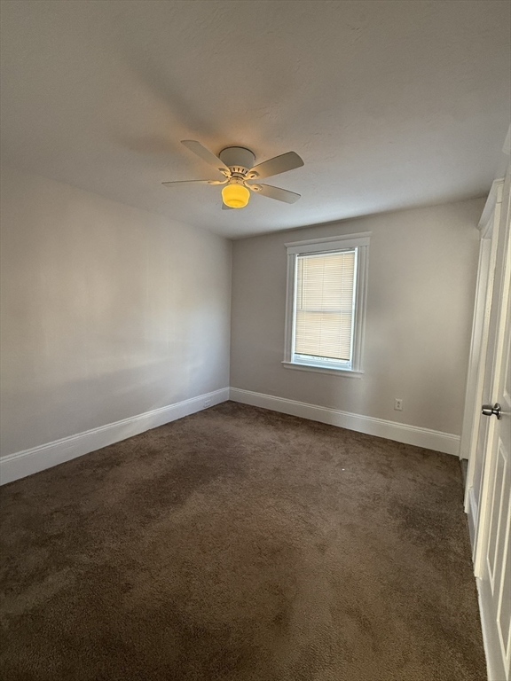 13 Sculpin Way, Unit 1 Swampscott, MA 01907 - Photo 3 of 9 an empty room with a window and chandelier fan