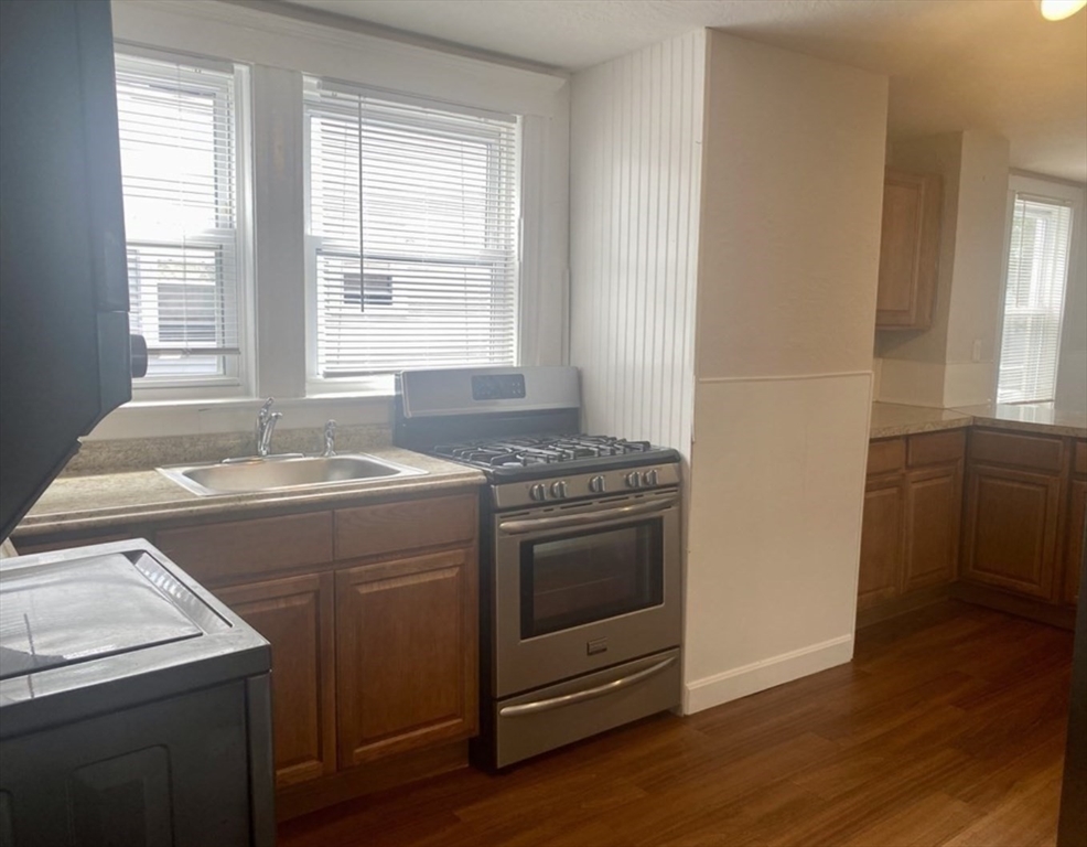 13 Sculpin Way, Unit 1 Swampscott, MA 01907 - Photo 4 of 9 a view of washer and dryer with wooden floor