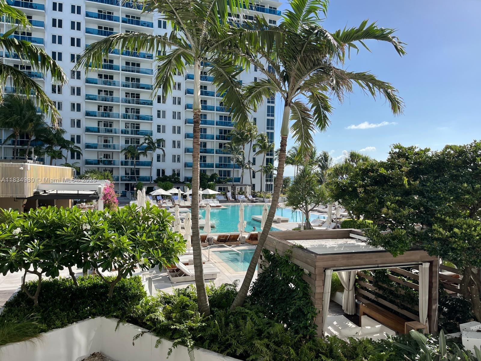 2301 Collins Avenue, Unit 415 Miami Beach, FL 33139 - Photo 15 of 23 a view of a patio with table and chairs and potted plants