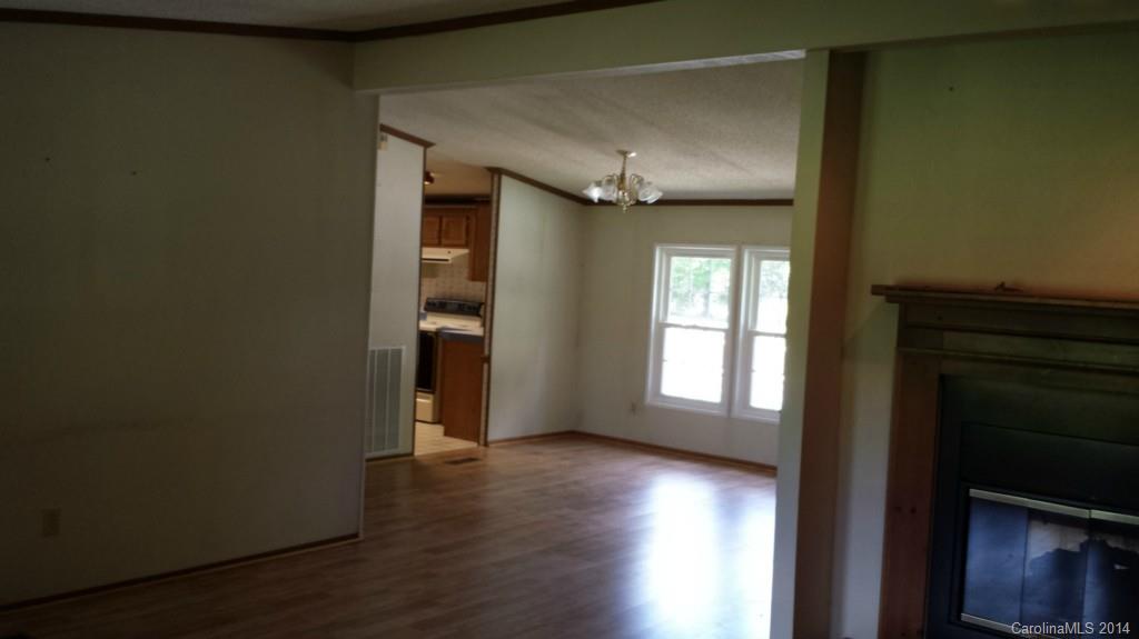 220 Trexler Road Salisbury, NC 28146 - Photo 8 of 13 an empty room with wooden floor and windows