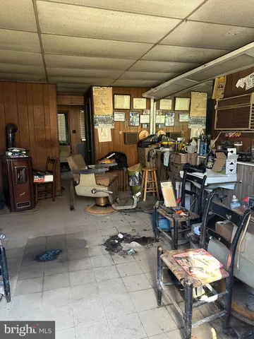 a living room with lots of gym equipment and a table