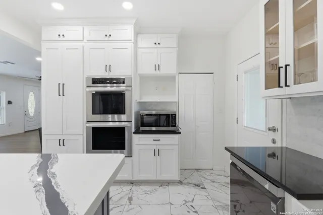 a kitchen with stainless steel appliances a stove a sink and a refrigerator