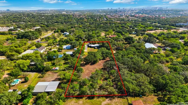 an aerial view of a houses with a yard