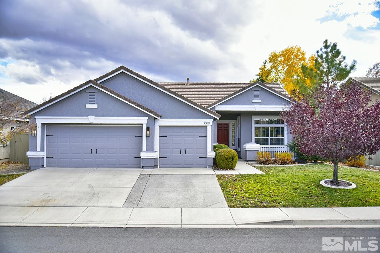 1680 Caliterra Way Reno, NV 89521 - Photo 1 of 34 a front view of a house with a yard and garage
