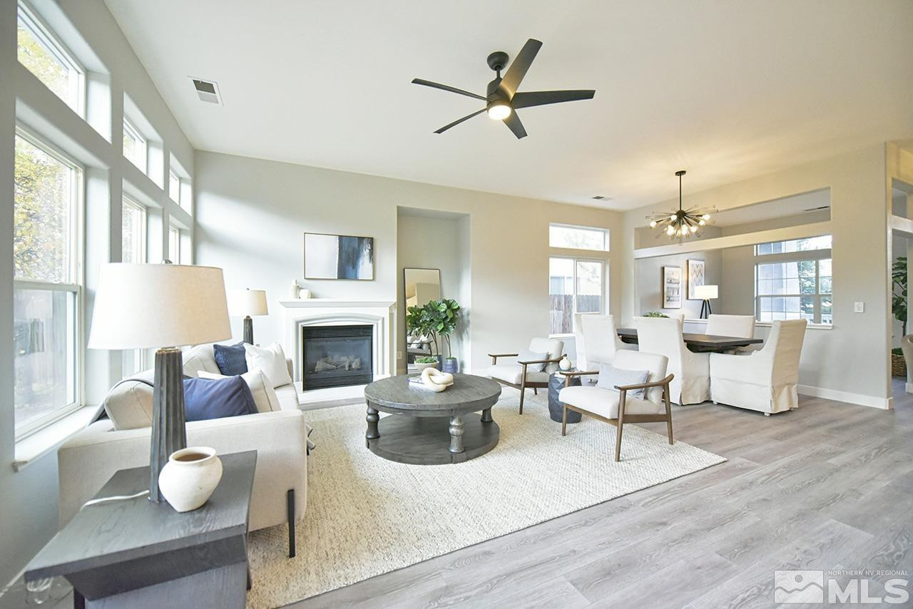 1680 Caliterra Way Reno, NV 89521 - Photo 12 of 34 a living room with furniture a fireplace and a large window