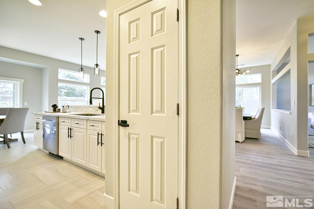 1680 Caliterra Way Reno, NV 89521 - Photo 18 of 34 a view of a hallway with bathroom and wooden floor