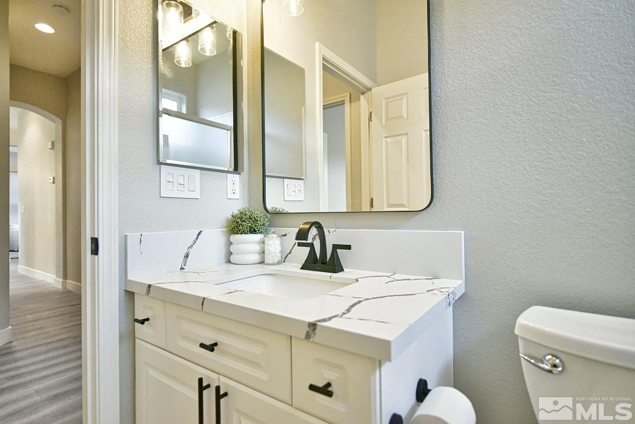 1680 Caliterra Way Reno, NV 89521 - Photo 24 of 34 a bathroom with a sink and a mirror