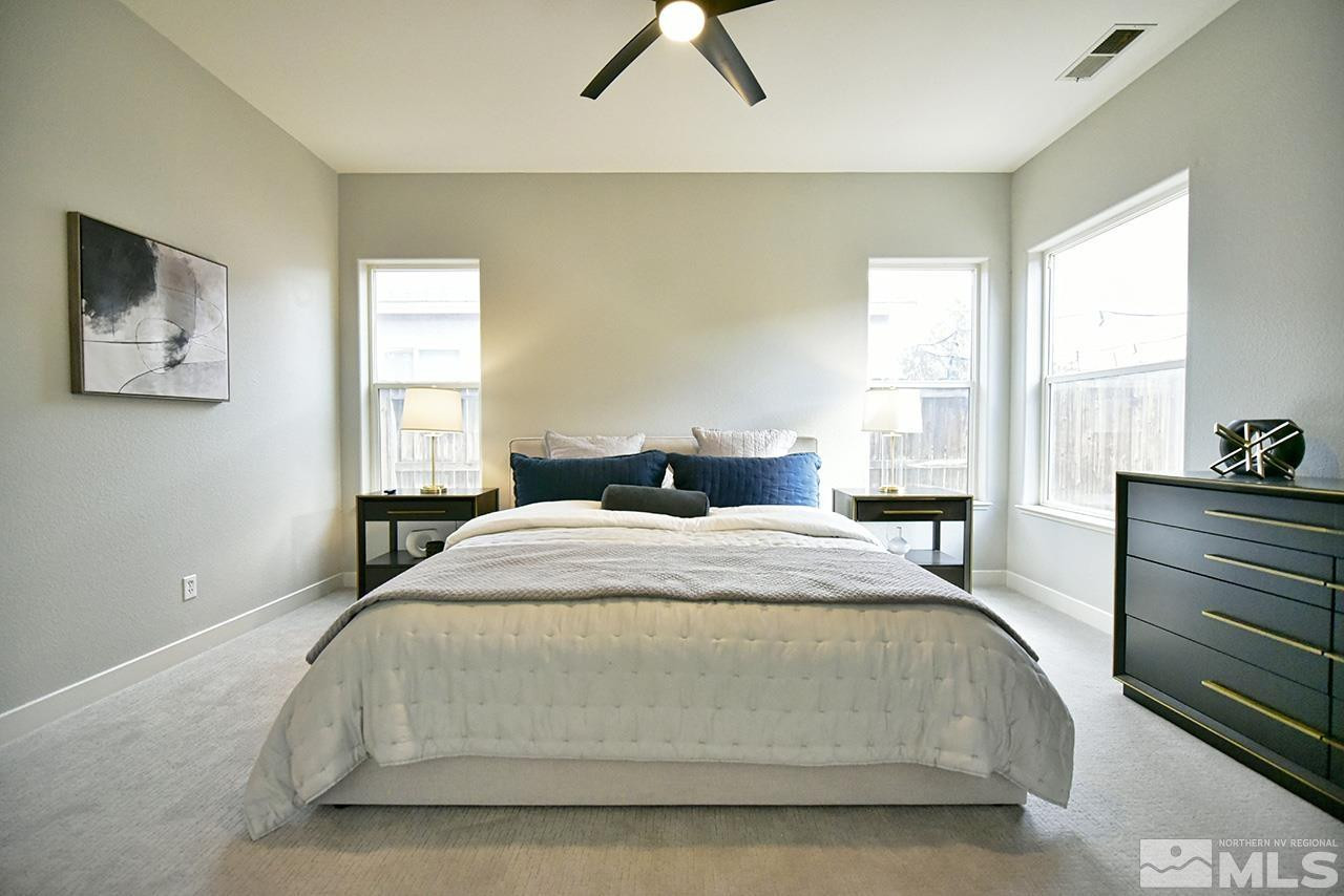 1680 Caliterra Way Reno, NV 89521 - Photo 25 of 34 a bedroom with a bed and a painting on the wall