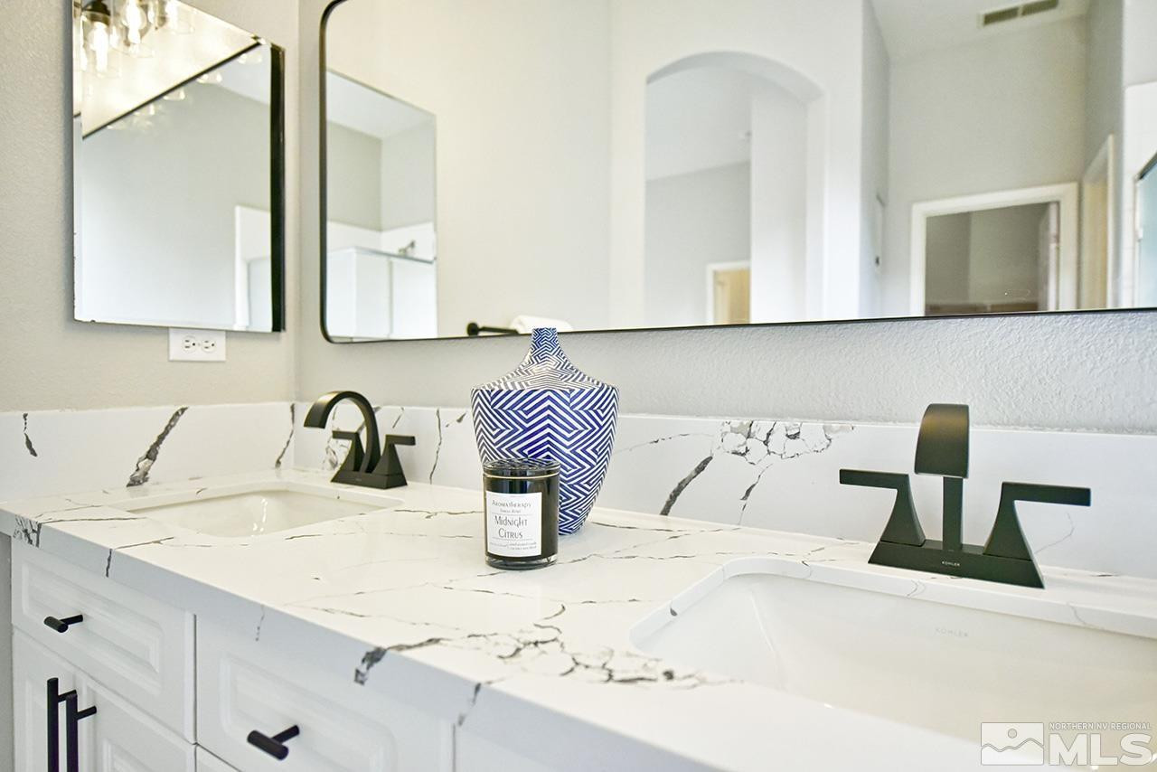 1680 Caliterra Way Reno, NV 89521 - Photo 29 of 34 a bathroom with a granite countertop sink and a mirror