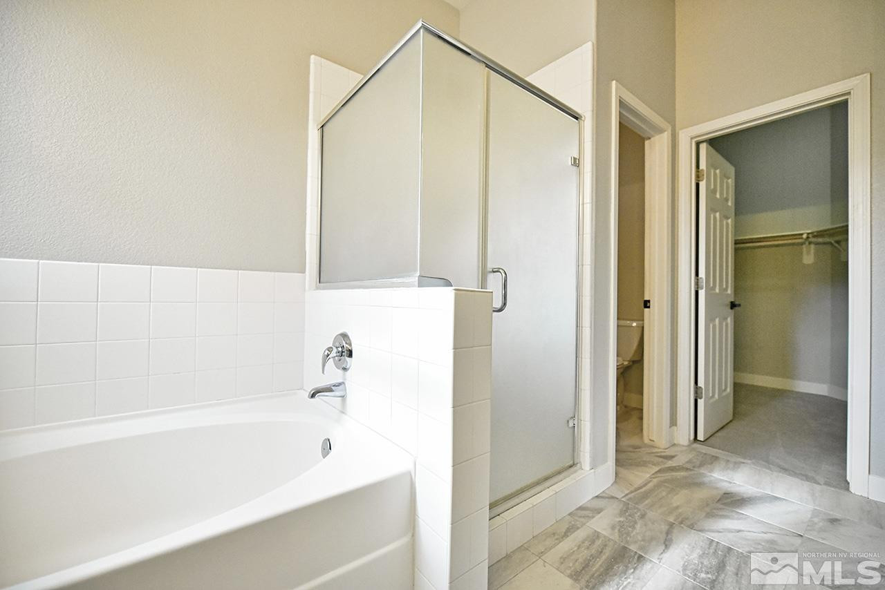 1680 Caliterra Way Reno, NV 89521 - Photo 30 of 34 a bathroom with a bathtub and a shower