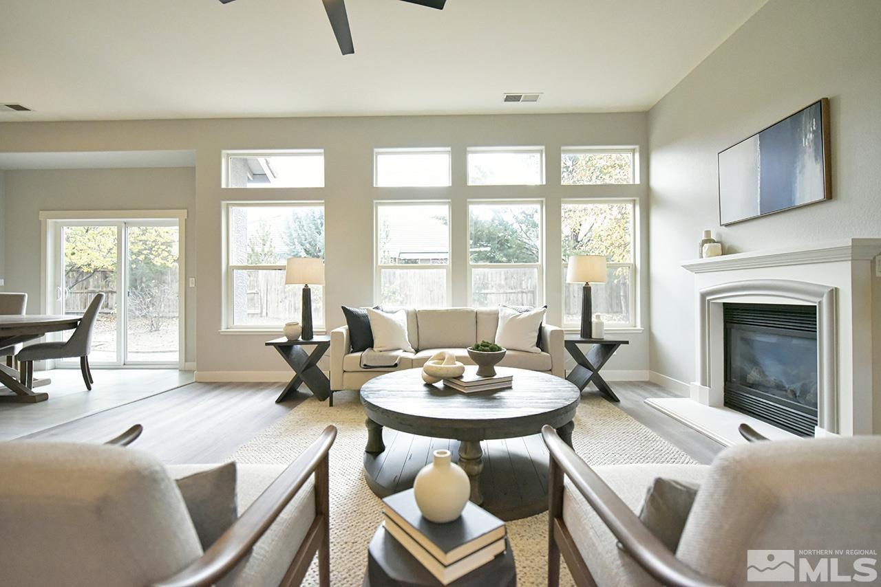 1680 Caliterra Way Reno, NV 89521 - Photo 9 of 34 a living room with furniture a fireplace and a large window