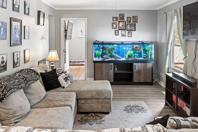 a living room with furniture a flat screen tv and a fireplace