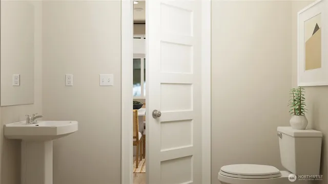 a bathroom with a sink toilet and a mirror