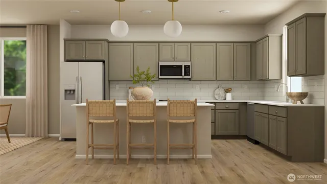 a kitchen with cabinets and stainless steel appliances