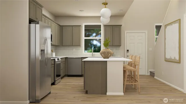 a kitchen with a sink cabinets and wooden floor