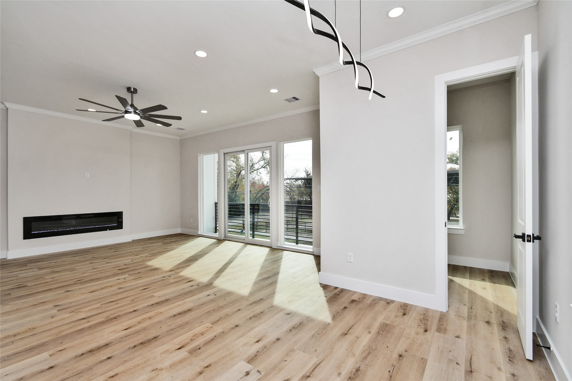 3233 Tuam Street Houston, TX 77004 - Photo 14 of 46 a view of an empty room with a window and wooden floor