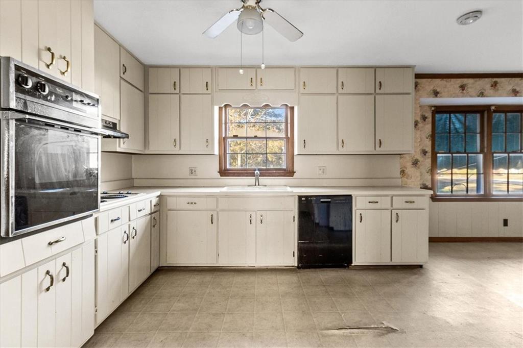 2075 Pinewood Drive Covington, GA 30016 - Photo 14 of 37 a kitchen with granite countertop white cabinets and white appliances