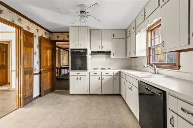 a kitchen with appliances cabinets and a sink