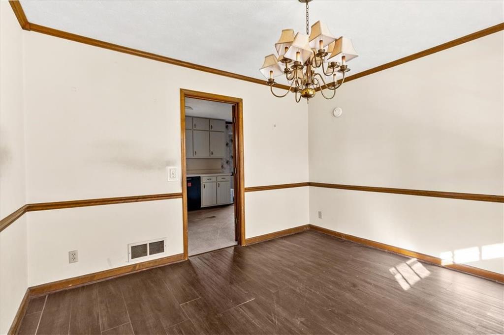 2075 Pinewood Drive Covington, GA 30016 - Photo 20 of 37 a view of a room with wooden floor and a chandelier