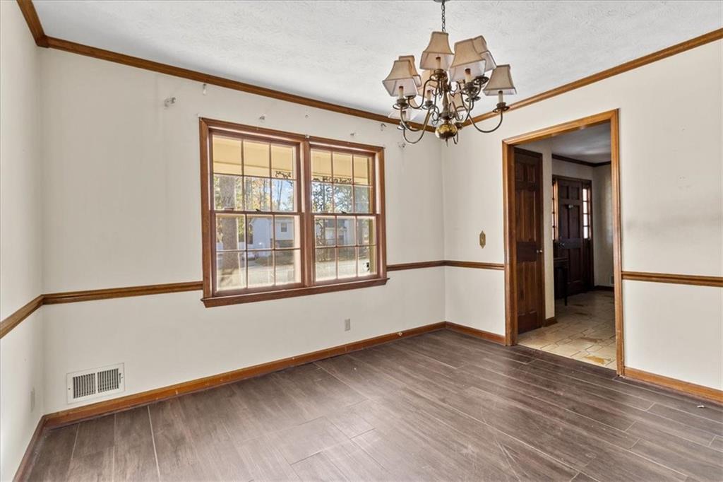 2075 Pinewood Drive Covington, GA 30016 - Photo 21 of 37 a view of an empty room with a window and wooden floor