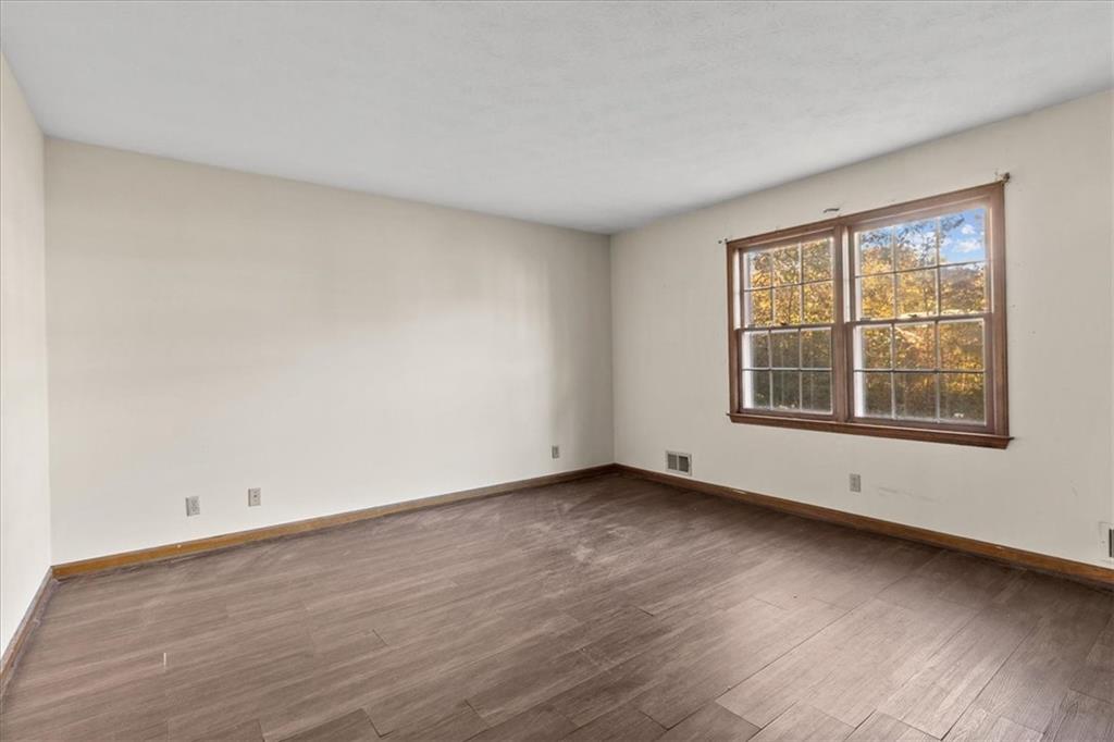 2075 Pinewood Drive Covington, GA 30016 - Photo 22 of 37 a view of an empty room with wooden floor and a window