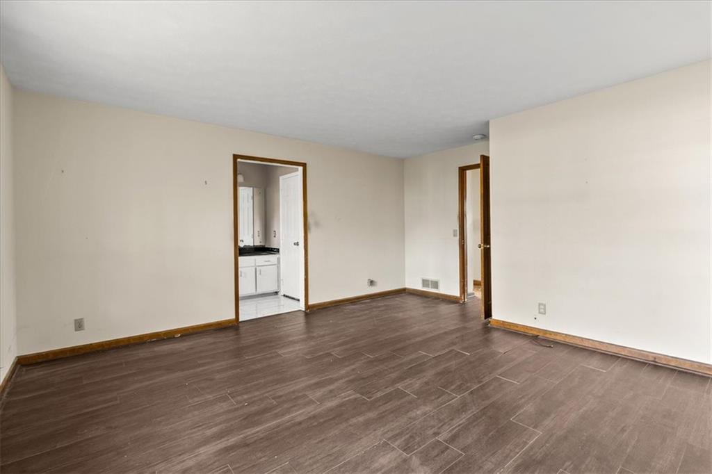 2075 Pinewood Drive Covington, GA 30016 - Photo 23 of 37 an empty room with wooden floor and mirror