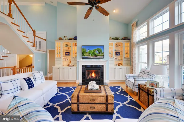 a living room with furniture fireplace and a large window