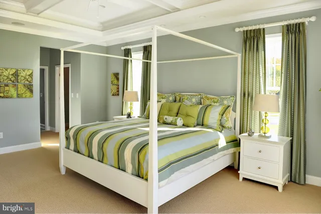 a bed sitting in a bedroom next to a window