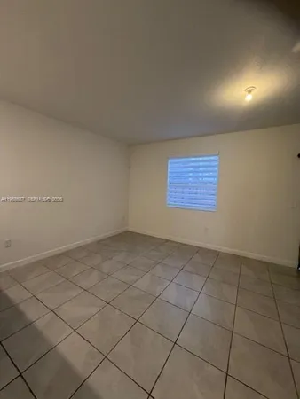 a view of an empty room and a window