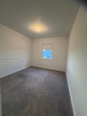 an empty room with a empty space and windows