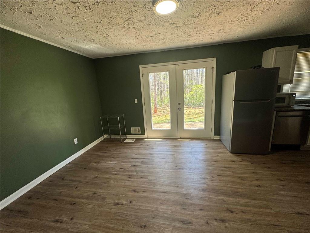 2536 Butner Road Atlanta, GA 30331 - Photo 9 of 19 an empty room with wooden floor and a refrigerator