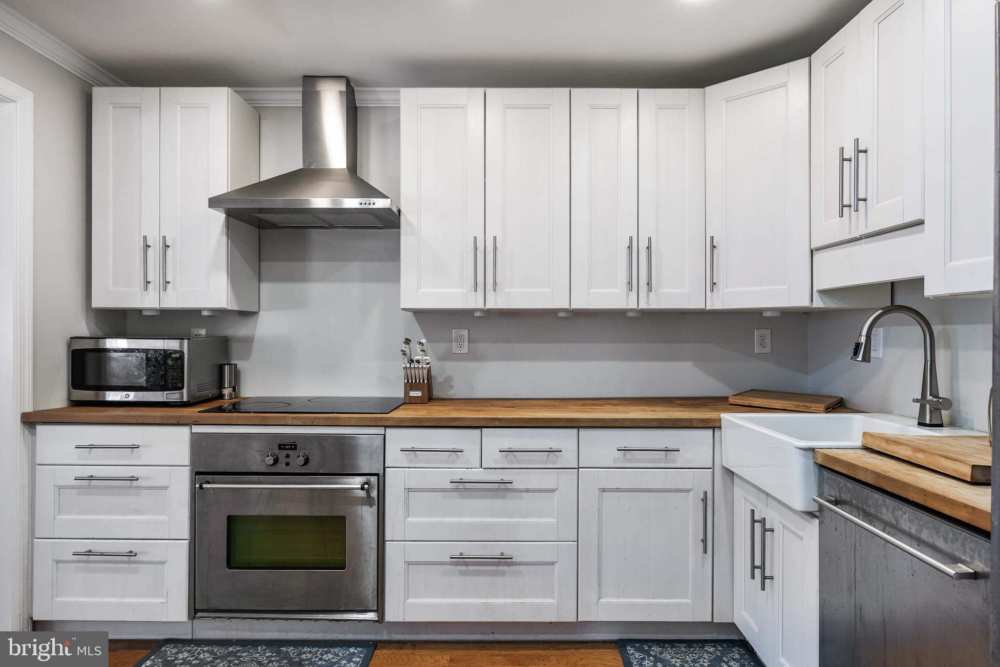 216 Uxbridge Cherry Hill, NJ 08034 - Photo 12 of 30 a kitchen with granite countertop white cabinets and stainless steel appliances