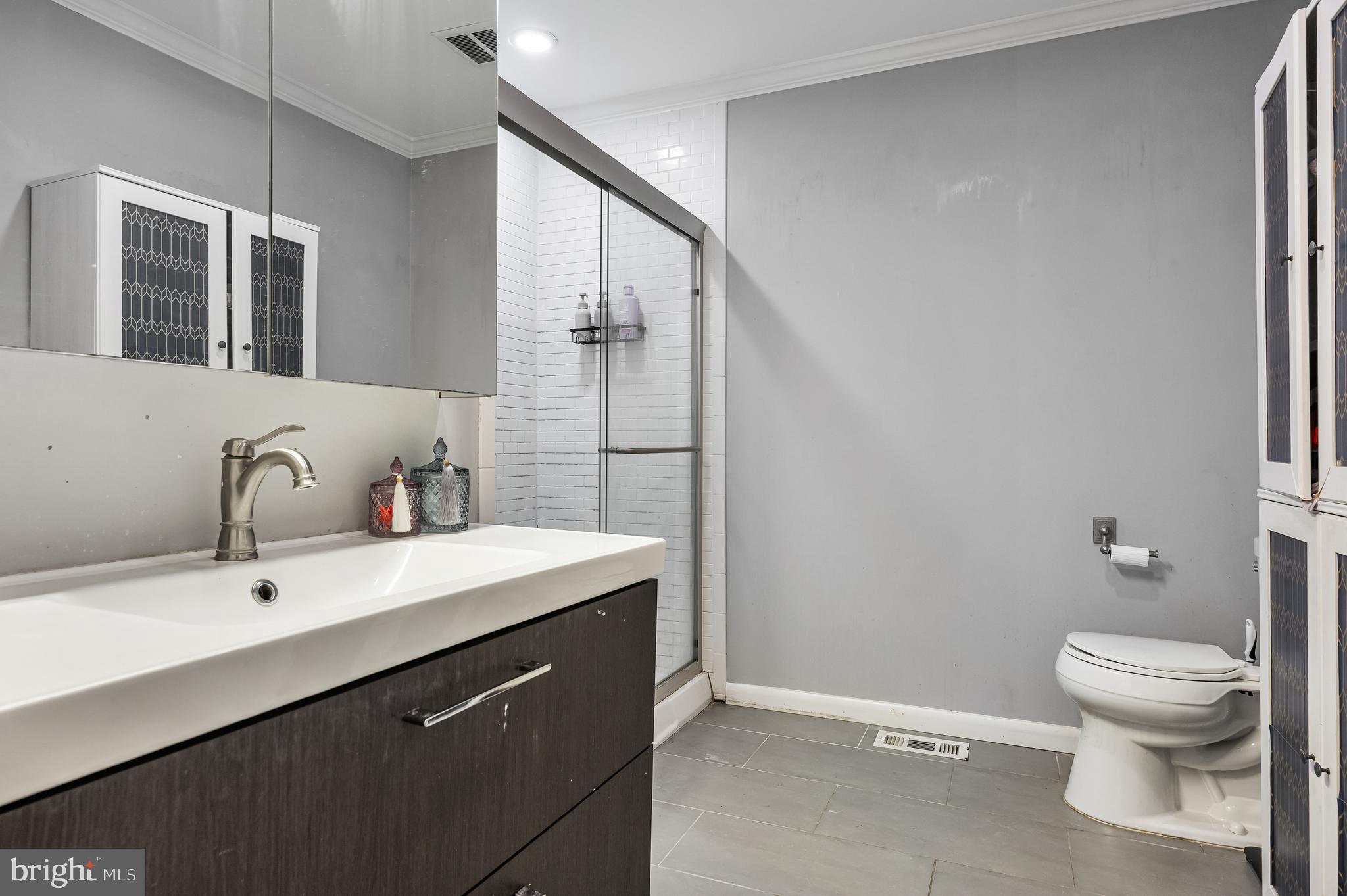 216 Uxbridge Cherry Hill, NJ 08034 - Photo 18 of 30 a bathroom with a sink toilet and mirror