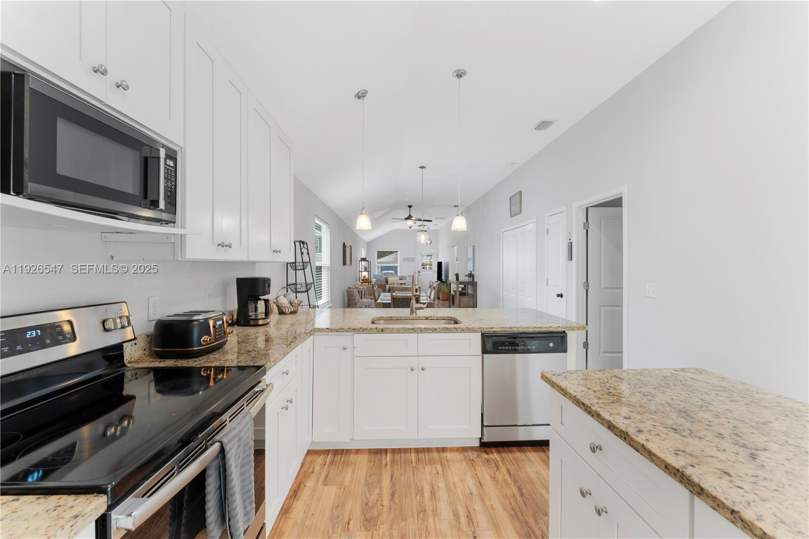 2 Poinciana Cove Road St. Augustine, FL 32084 - Photo 20 of 44 a kitchen with stainless steel appliances granite countertop a stove top oven a sink a microwave and cabinets