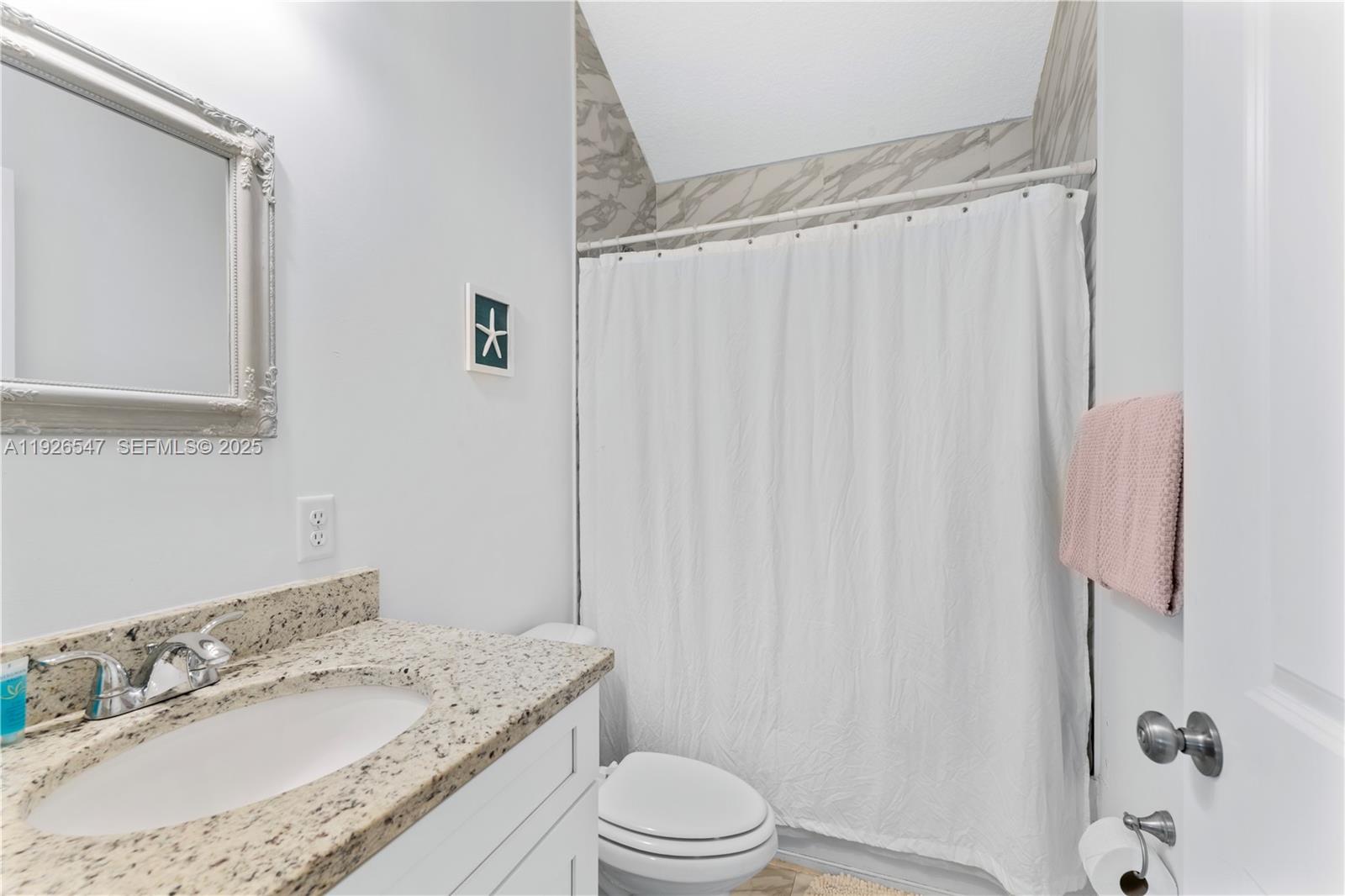 2 Poinciana Cove Road St. Augustine, FL 32084 - Photo 27 of 44 a bathroom with a granite countertop sink toilet and shower