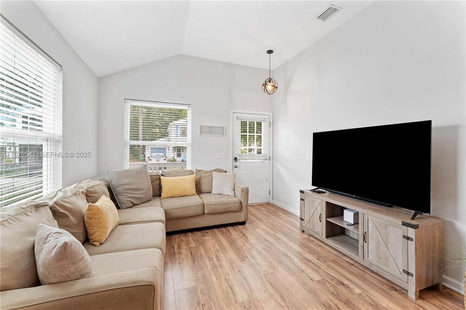 2 Poinciana Cove Road St. Augustine, FL 32084 - Photo 9 of 44 a living room with furniture and a flat screen tv
