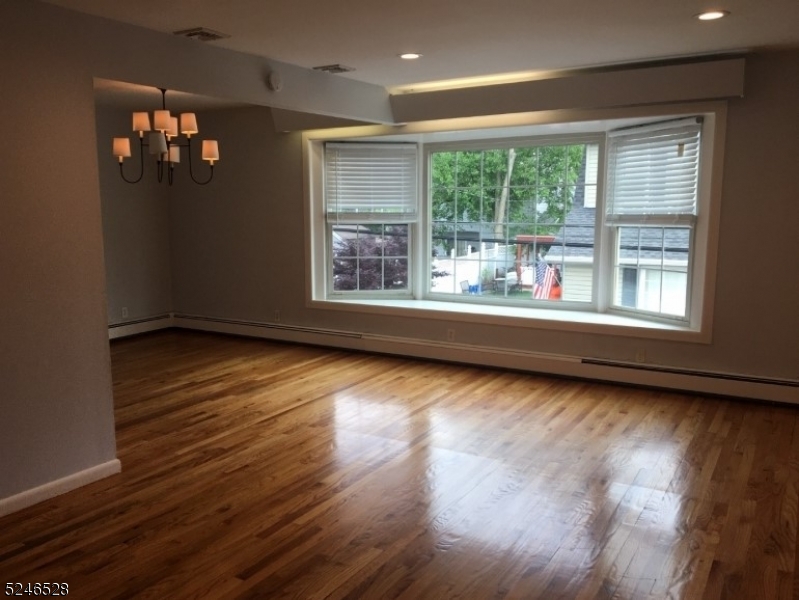 38 Emily Avenue, Unit 2 Union, NJ 07088 - Photo 2 of 9 a view of an empty room with wooden floor and a window