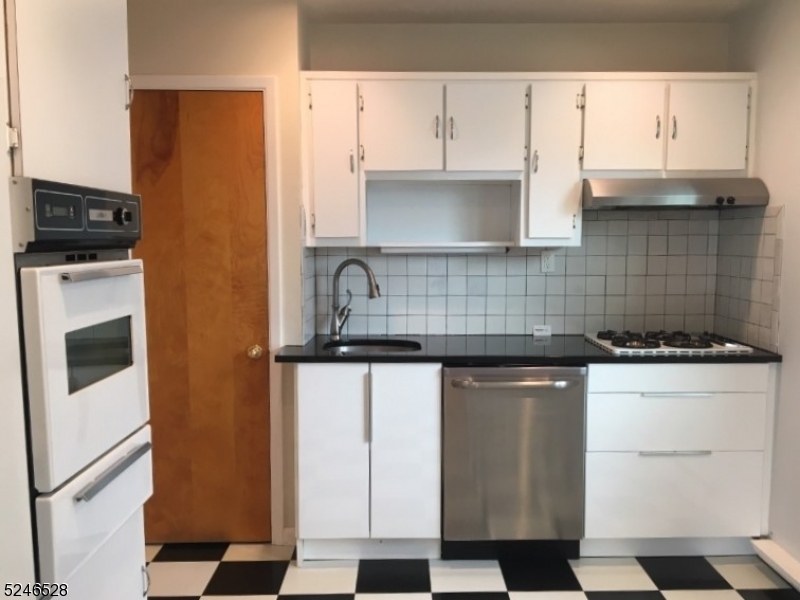 38 Emily Avenue, Unit 2 Union, NJ 07088 - Photo 5 of 9 a kitchen with stainless steel appliances granite countertop a stove a sink and a refrigerator