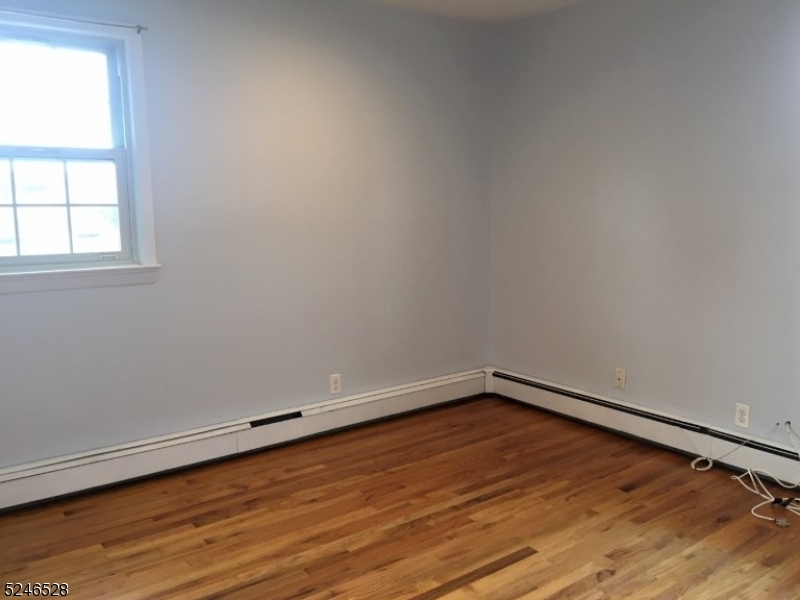 38 Emily Avenue, Unit 2 Union, NJ 07088 - Photo 7 of 9 an empty room with wooden floor and windows