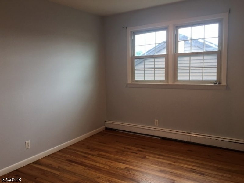 38 Emily Avenue, Unit 2 Union, NJ 07088 - Photo 8 of 9 an empty room with wooden floor and windows