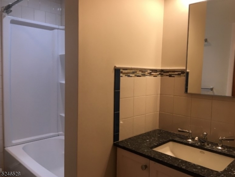 38 Emily Avenue, Unit 2 Union, NJ 07088 - Photo 9 of 9 a bathroom with a sink and a mirror