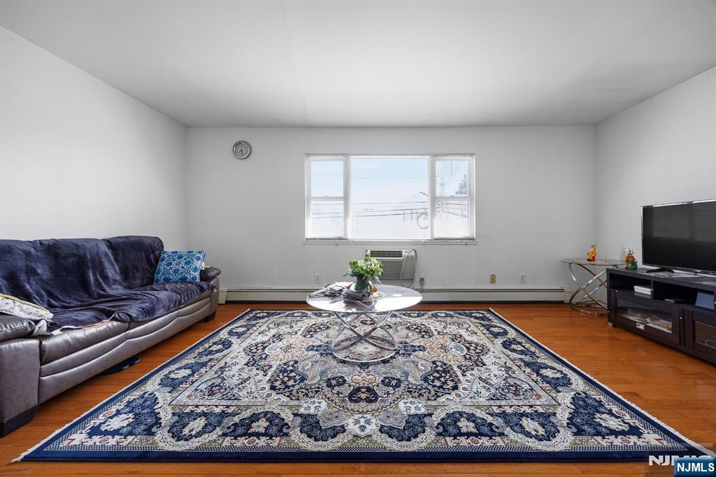 747 Riverside Avenue, Unit C1 Lyndhurst, NJ 07071 - Photo 3 of 16 a living room with a couch and a flat screen tv