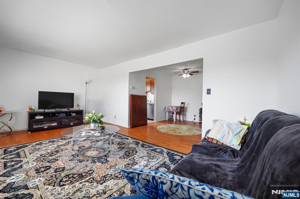 747 Riverside Avenue, Unit C1 Lyndhurst, NJ 07071 - Photo 4 of 16 a living room with furniture and a flat screen tv