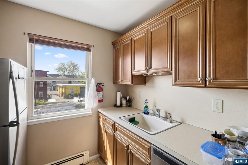 747 Riverside Avenue, Unit C1 Lyndhurst, NJ 07071 - Photo 8 of 16 a kitchen with a sink cabinets and a window