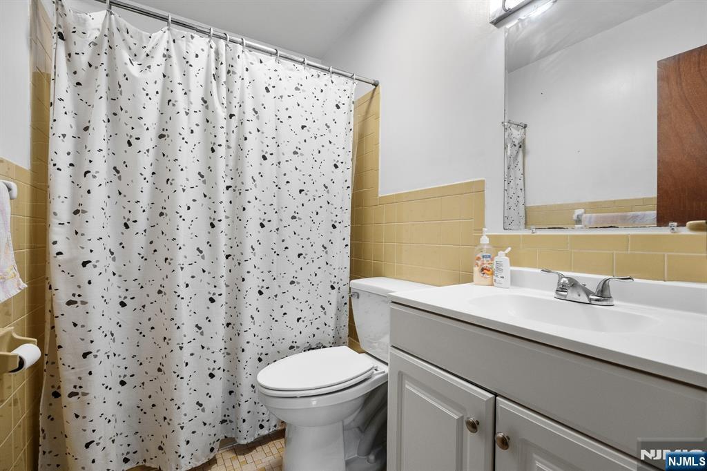 747 Riverside Avenue, Unit C1 Lyndhurst, NJ 07071 - Photo 10 of 16 a bathroom with a sink a toilet and a mirror